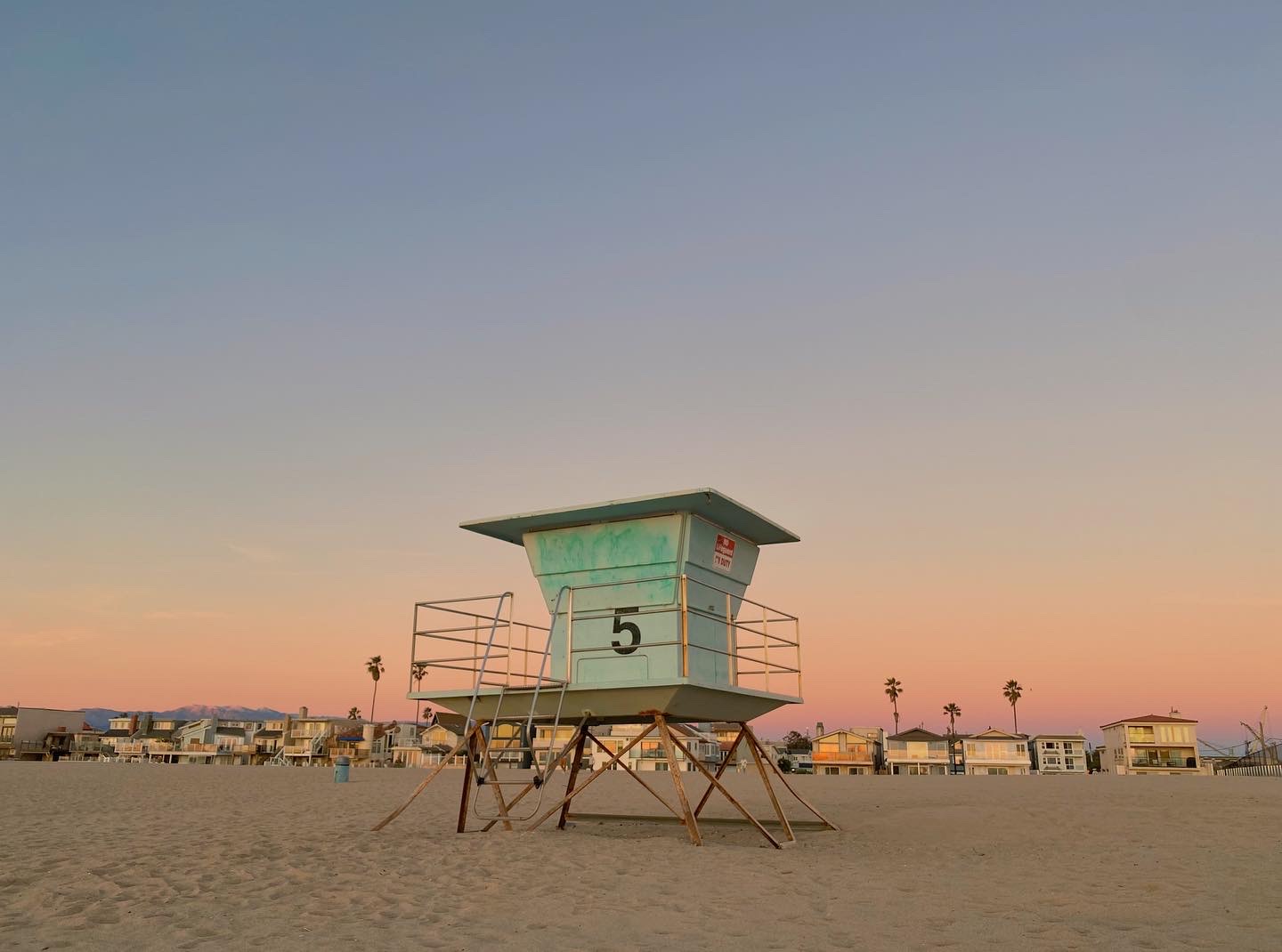 Lifeguard tower 5 on the beach under a pink evening sky