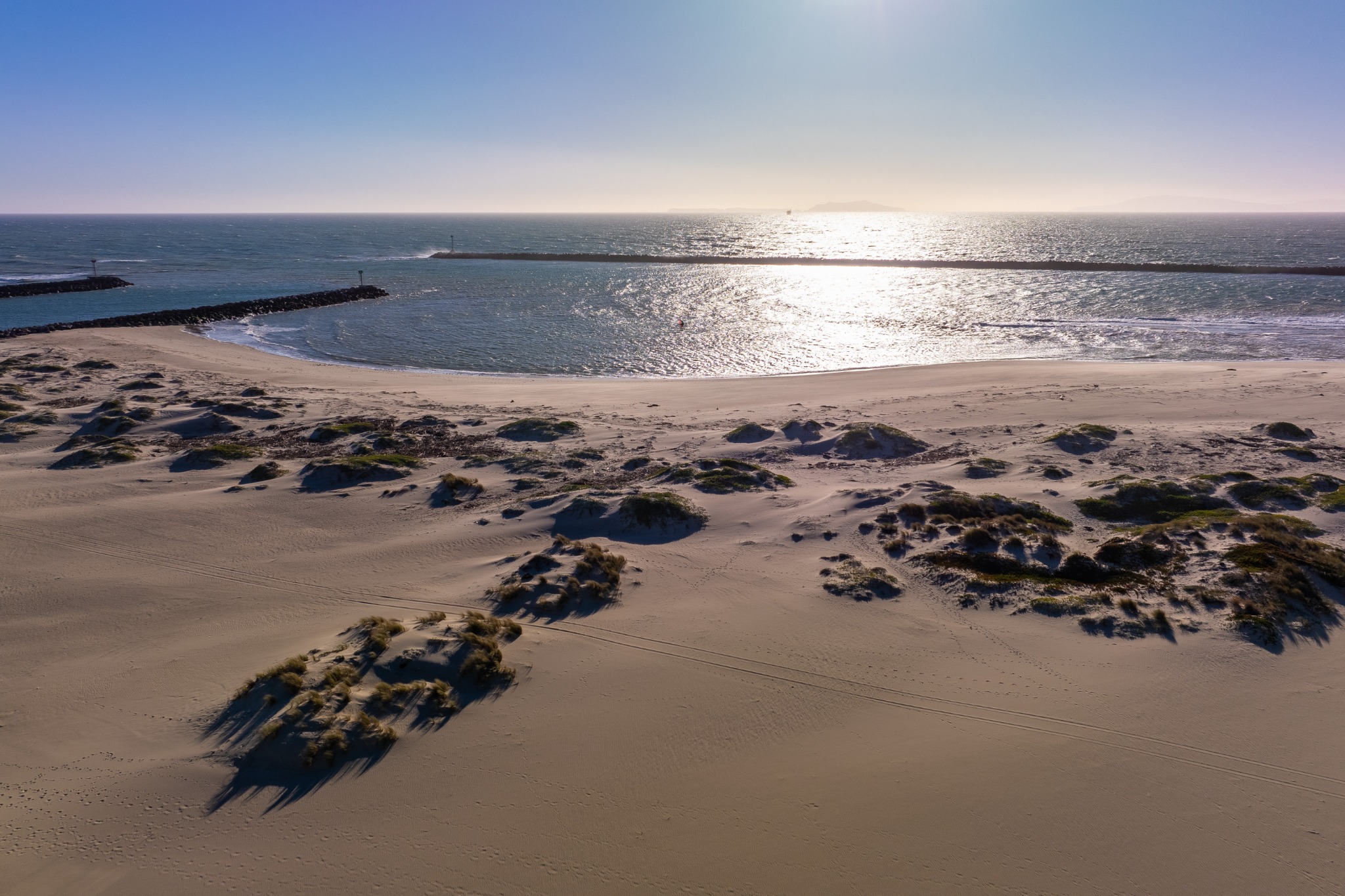Channel Islands Harbor entrance, sandy shoreline and breakwaters in Oxnard