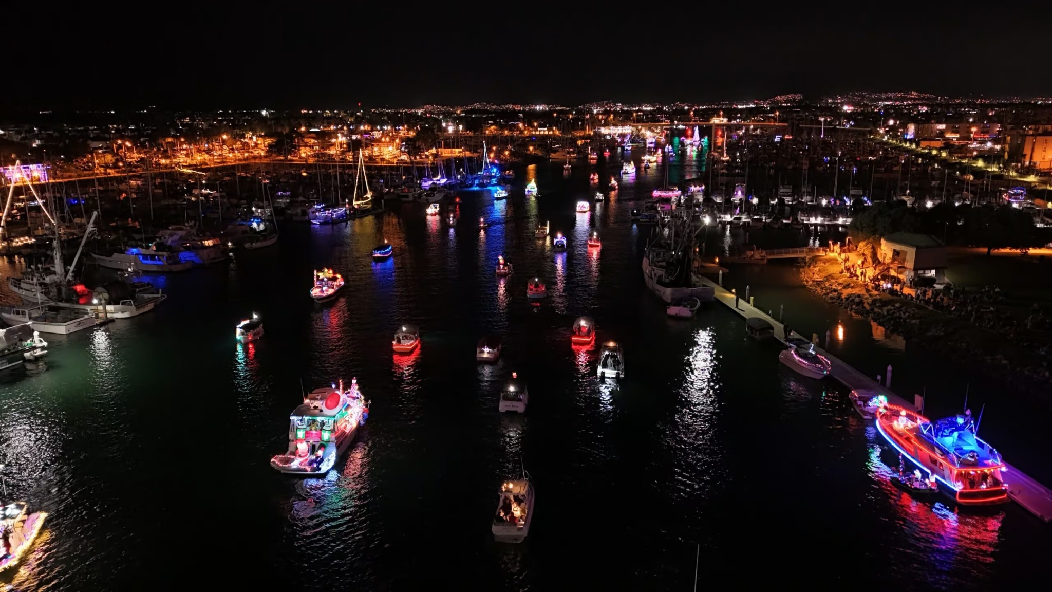An aerial night view of decorated boats at a previous Oxnard Parade of Lights